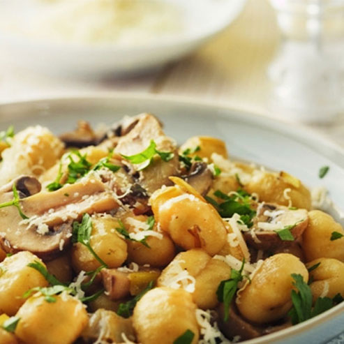 Bowl of mushroom gnocchi with parmesan