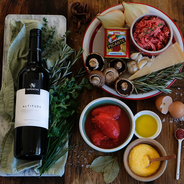 Bottle of Nepenthe Tempranillo next to the ingredients used to make spicy meatballs.