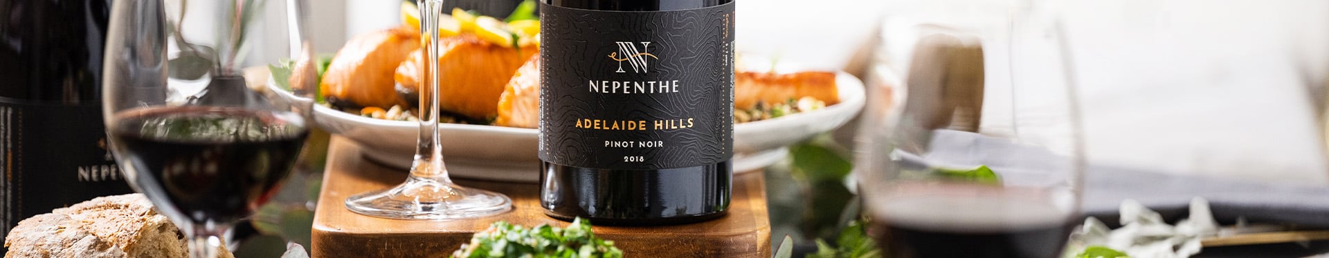 Bottle of Pinot Noir with a glass of wine next to it