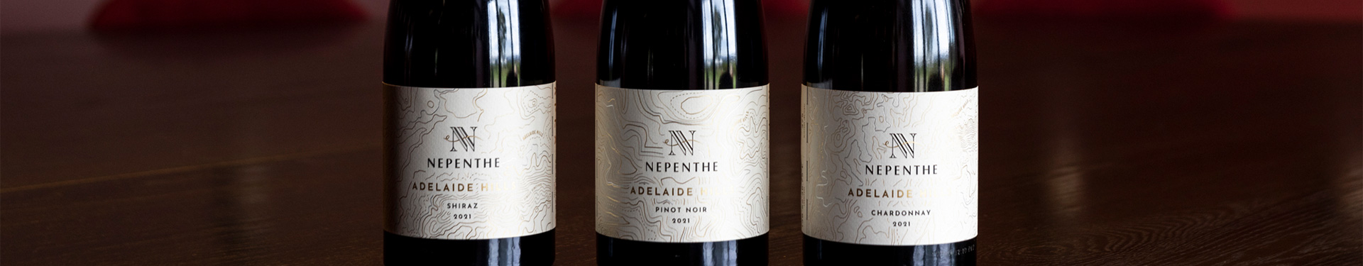 Nepenthe Apex bottle on a wood ground
