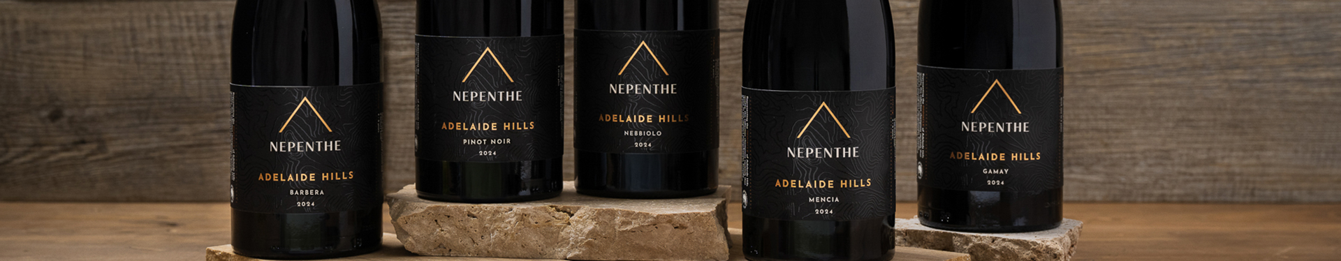 Bottles of Nepenthe Pinnacle range stood on textured rocks.
